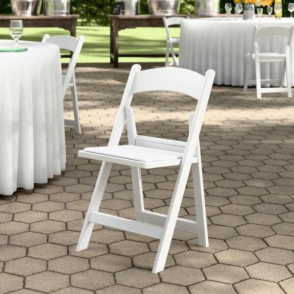 White resin padded folding chair for wedding and event rentals